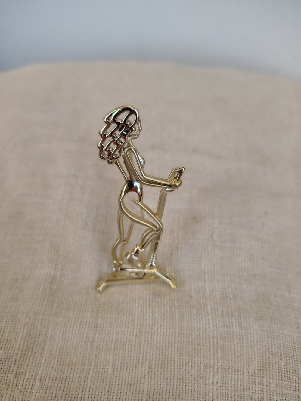 Vintage Gold Tone open work silhouette of a woman on a stair stepper